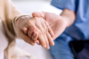 Home Health Care Companion holding hands with client