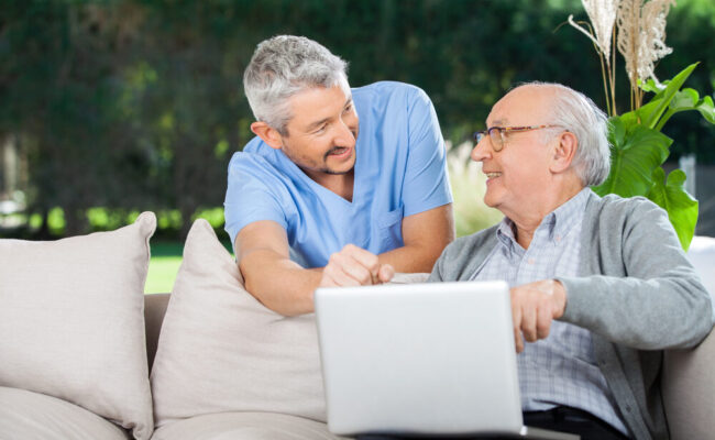 Male Home Health Aide Helping a Client