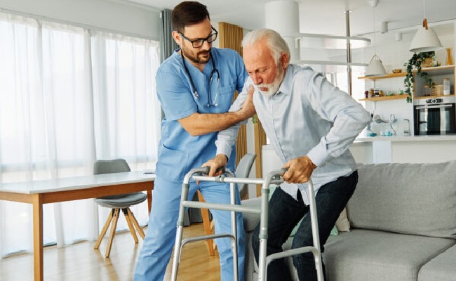 Home Health Aide assisting client stand