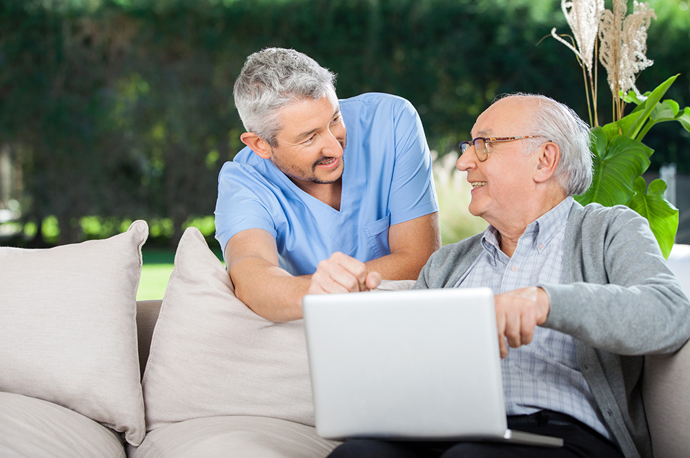 Male Home Health Aide Helping a Client